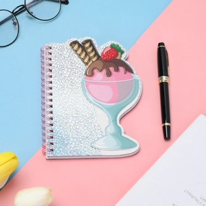 Close-up of pink laser glitter coil notebook featuring a 3D ice cream cup cover design