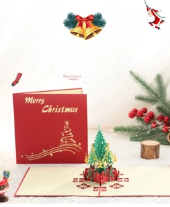 Detail of 3D pop-up Christmas tree card with green and gold laser-cut paper layers
