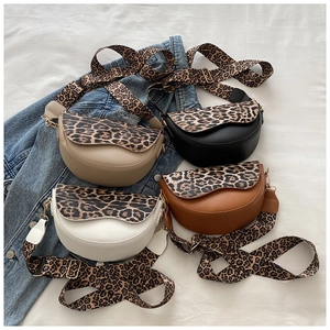 Detail view of saddle bags in four colors with leopard print flaps and wide straps