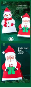 Detail of Santa and Snowman paper gift boxes with vibrant Christmas patterns and folding design