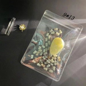 Detailed view of 9x13cm transparent jewelry storage bag with necklace on black surface