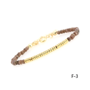 Detail of faceted brown beads bracelet with gold-plated ribbed beads and lobster clasp