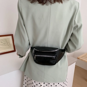 Classic black PU leather waist bag with silver zippers shown on a stylish model