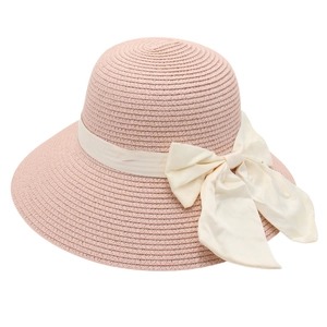 Women's pink woven straw sun hat with a large cream satin bow for summer beach elegance