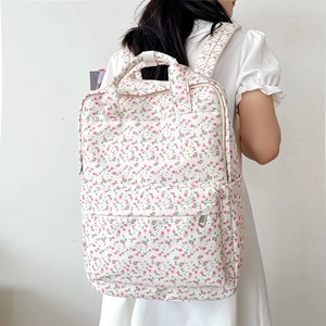 Close-up of floral backpack with front zipper pocket and side water bottle holder