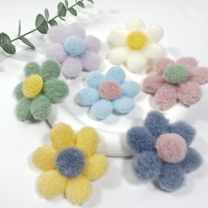 Detailed view of colorful felt flower accessories in various soft pastel shades
