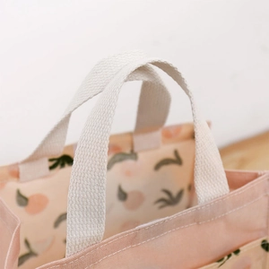 Minimalist canvas tote bag with peach fruit print and reinforced cotton handles
