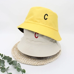 Double-sided reversible bucket hats in yellow and beige with C letter embroidery
