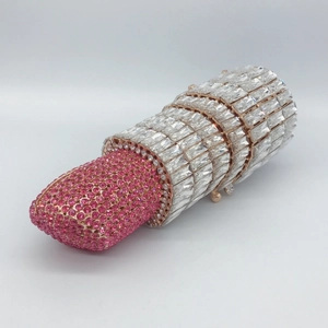 Close-up of luxury lipstick-shaped evening clutch with sparkling pink and silver crystals