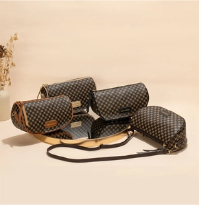 Elegant dark brown saddle bags with geometric print patterns on a gold mirror tray
