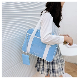 Detail of light blue JK ita bag showing heart window and matching small coin purse