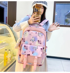 Detail of pink and purple gradient school backpack with cute bear and luck lettering