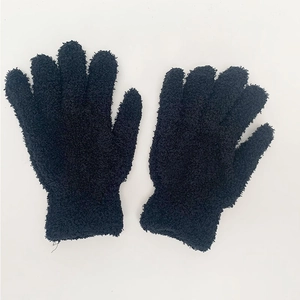 Detail of soft black coral fleece thermal gloves showing thick plush texture and ribbed cuffs