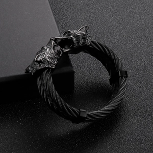 Close-up of black wolf head viking bracelet with twisted stainless steel wire cables