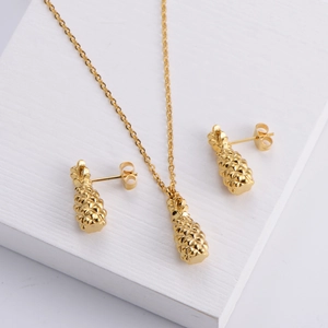 Golden pineapple jewelry set featuring a necklace and stud earrings with detailed texture