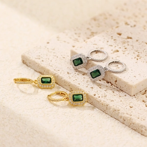 Close-up of gold and silver S925 sterling silver emerald hoop earrings with tiny pavé diamonds