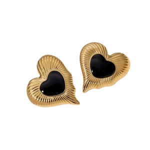Vintage gold-plated heart stud earrings with black enamel center on a white background