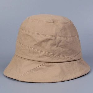 Detail view of khaki cotton bucket hat featuring multi-layered horizontal stitching design
