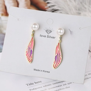 Elegant wing earrings with purple gradient wings, white pearls and sparkling rhinestones
