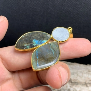 Close-up of gold-plated labradorite and agate crystal cluster stone pendant
