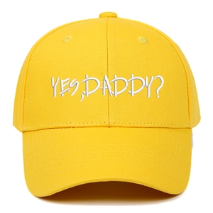 Close-up of yellow baseball cap featuring white YES DADDY? embroidery and twill cotton texture