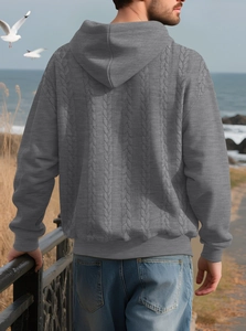 Rear view of a grey cable-knit hoodie for men featuring a textured hood and rib-knit cuffs