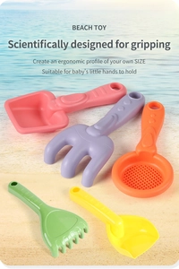 Detail of colorful beach toy set with ergonomic shovel and rake for toddler hands