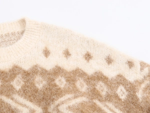 Close-up of vintage jacquard knit sweater featuring warm white and caramel brown argyle pattern
