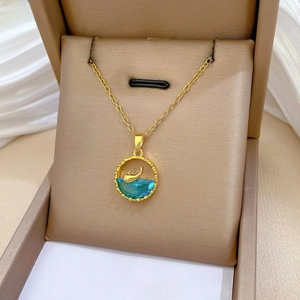Close-up of titanium whale pendant necklace with blue crystals on silk background