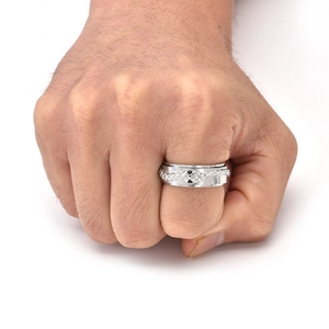 Close-up of a rotating snake ring in silver titanium steel with black gemstone eyes