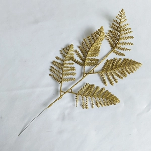 Glittering gold artificial fern leaf branch for Christmas trees and holiday decorations