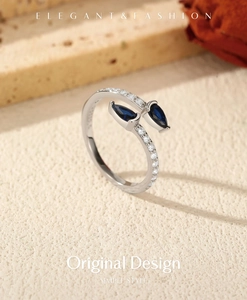 Detail of adjustable S925 silver ring featuring blue pear-cut stones and crystal pavé