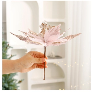 Detail of pink velvet Christmas flower with gold glitter petals for tree decoration