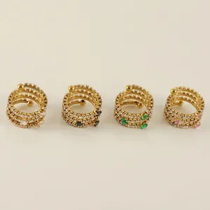 Set of four gold stainless steel multi-layer spiral rings with cubic zirconia heart gems
