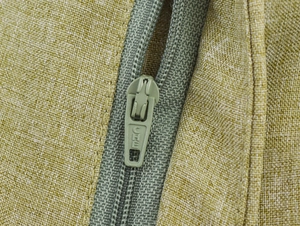 Close-up of green linen fabric texture with a high-quality concealed zipper detail
