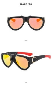 Detail view of sport sunglasses with black frames and red-orange mirrored lenses