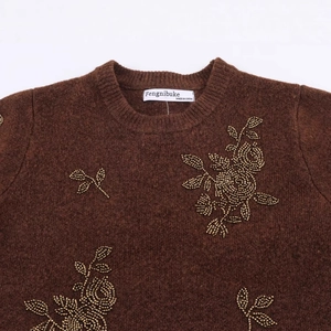 Short sleeve brown knit sweater featuring intricate gold beaded floral patterns