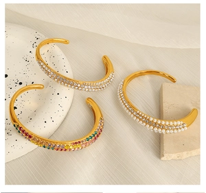 Three gold-plated C-shaped open bracelets featuring white zircon, colorful gems and pearls