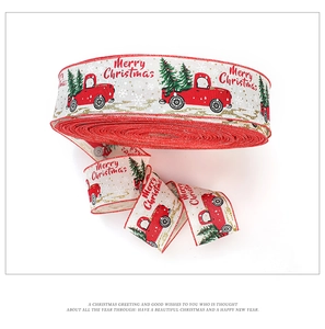 Detail of Christmas ribbon rolls with red truck and tree patterns for gift wrapping