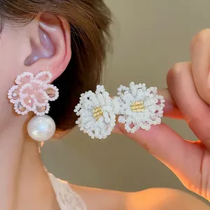 Elegant flower-shaped beaded stud earrings with pink crystals and large round white pearls