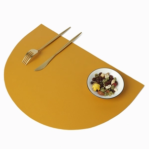 Nordic yellow semi-circle PU leather placemat with golden cutlery on white background