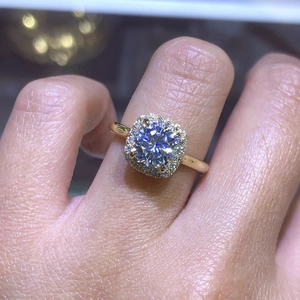 Macro view of a luxury halo ring with a round center stone and pave-set square diamonds