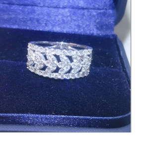 Elegant lace leaf pattern ring with pavé moissanite in a blue velvet jewelry box