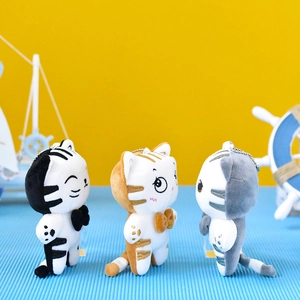 Three adorable plush cat keychains in various colors featuring cute bow ties and charms