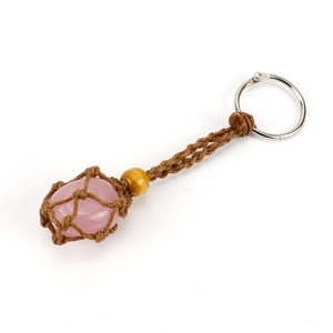 Detail of a pink quartz stone secured in a brown braided rope pouch keychain