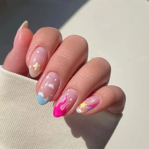 Detail of long almond press-on nails with hand-painted flame, stars and floral patterns