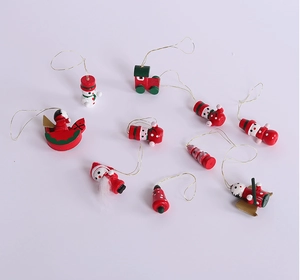 Flat lay of wood Christmas tree ornaments set including Santa and snowman with gold cords