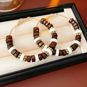 Detail of 18k gold plated hoop earrings with tiger eye and white turquoise beads