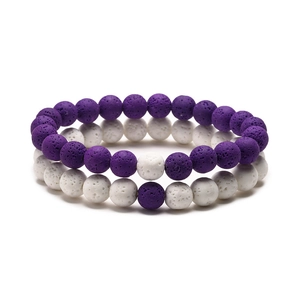 Detail of purple and white lava stone beaded bracelets showing porous mineral texture