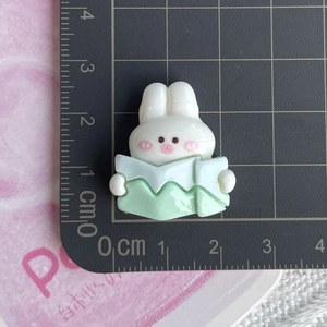 Size detail of miniature resin bunny figurine for DIY crafts on a measuring mat